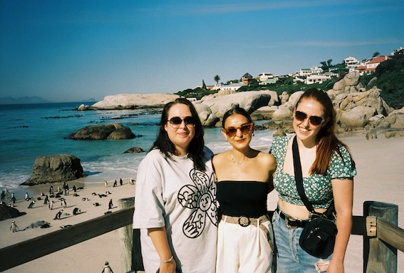 A film photo of Hannah, Sophie, and Stacey at Boulders Beach