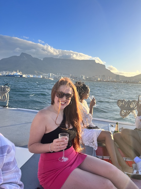 Hannah with a glass of champagne on the sunset cruise