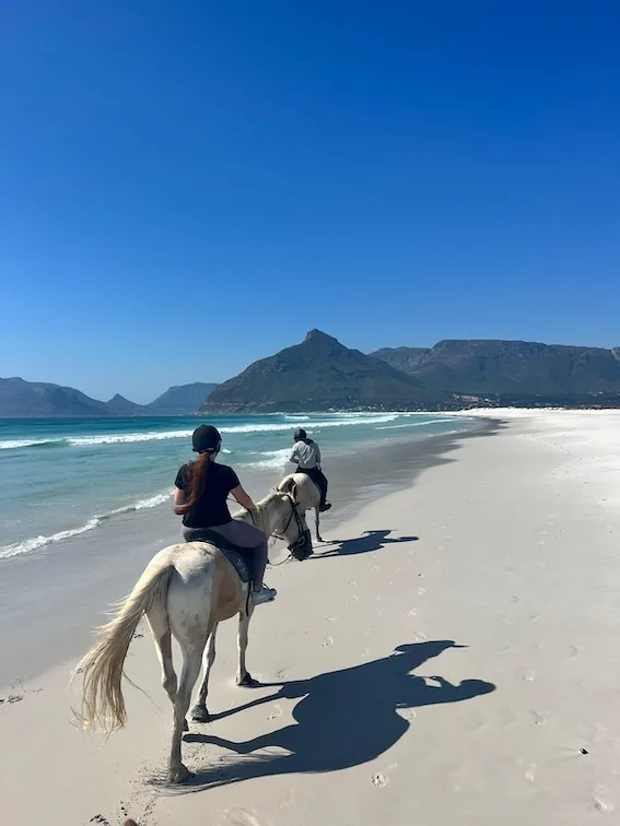 Hannah and leader horse riding on the beach
