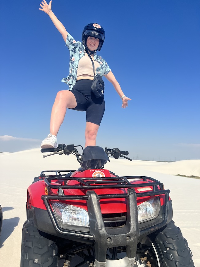 Hannah standing on a quad bike