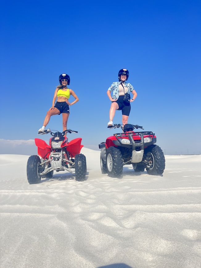 Sophie and Hannah standing on ATVs