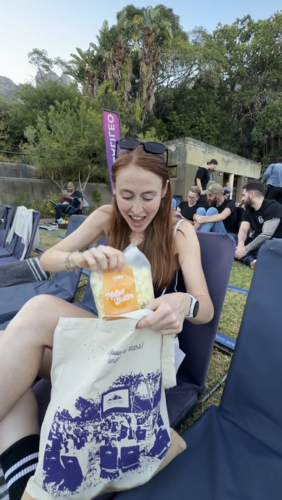 Hannah opening popcorn and Galileo tote