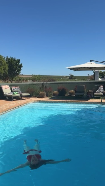 Hannah floating in the pool at Eikendal Lodge