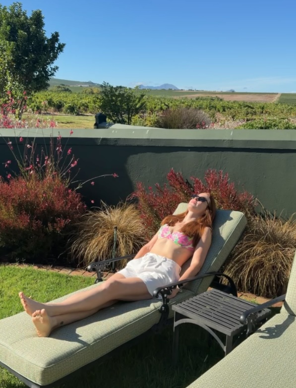 Hannah laying on a sunbed at Eikendal Lodge