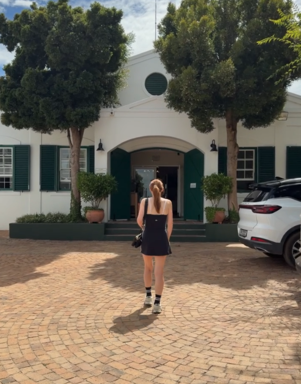 Hannah walking into Eikendal Lodge