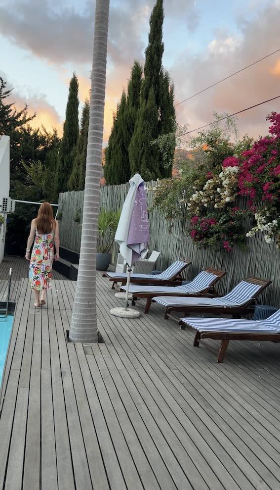 Hannah walking by the pool at ThLAB Franschhoek at sunset